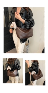 Close-up of deep brown vintage PU leather tote bag with white bunny plush charm detail