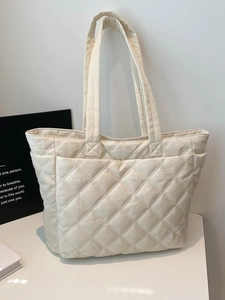 Beige quilted tote bag with diamond stitching and shoulder straps for daily commuting