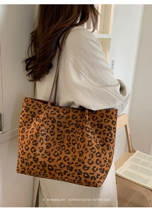 Close-up of a leopard print oversized tote bag with long shoulder straps for daily commute