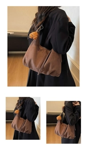 Close-up of vintage brown suede tote bag with fringe detail and cute bear charm