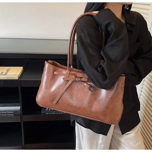 Retro caramel brown tote bag with metal buckle detail and long shoulder straps