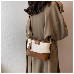 Detail of checkered crossbody bag with leather trim and wide floral shoulder strap