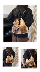 Detail view of large canvas tote bag with brown leather trim and cute bear charm