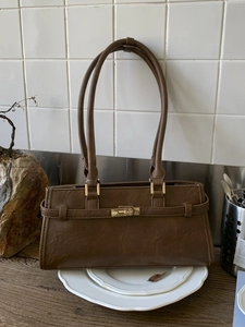 Vintage brown textured leather baguette tote bag with golden twist lock and slim straps
