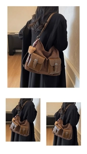 Detail of dark brown suede tote bag with front pockets, silver buckles and bear charm