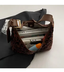 Detailed interior of leopard print tote bag with magnetic closure and brown leather straps