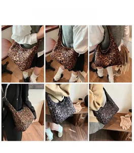 Close-up of leopard print tote bags in brown and grey colors worn by a model in a cafe