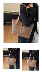 Close-up of brown pebbled leather tote bag with gold metal lock and shoulder strap detail