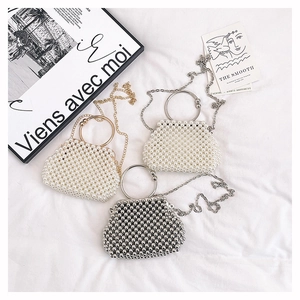 Handmade beaded handbags in white pearl and silver finishes with elegant metal handles