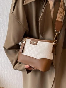 Brown and white plaid embossed hobo bag with wide printed shoulder strap and tassel
