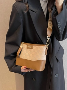 Women's checkered hobo bag with wide strap and fashion plaque on neutral background