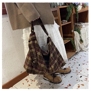 Close-up of brown and purple checkered woolen tote bag with vintage gold metal hardware