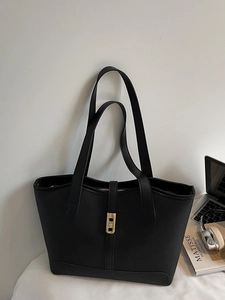 Minimalist black lychee leather tote bag with gold buckle and long shoulder straps