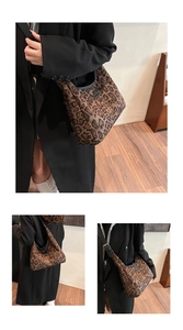 Detail of leopard print tote bag featuring plush fabric texture and wide shoulder strap
