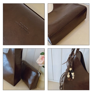 Detail view of vintage dark brown leather tote bag with small pouch and beaded charm