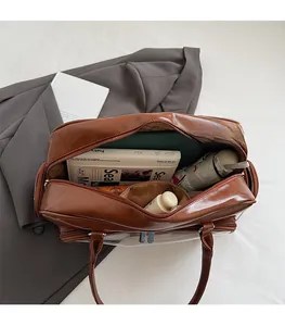 Detail view of spacious brown tote bag with PVC stitching showing interior capacity