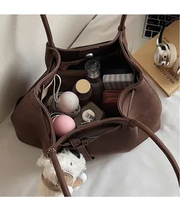 Interior view showing the large capacity of the vintage tote bag with various items