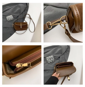 Close-up of brown suede and smooth leather texture with gold-toned metal hardware