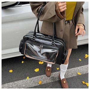 Chic black patent leather shoulder bag featuring a unique clear front zipper compartment