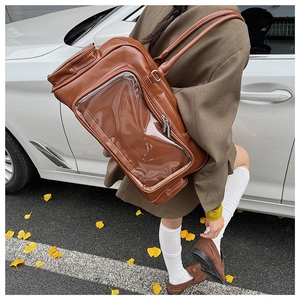 Detailed view of a brown ita bag with a transparent window in an autumn outdoor setting