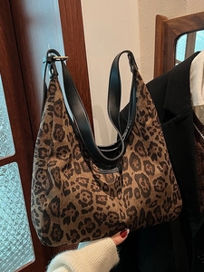 Borsa tote retrò leopardata con manici in pelle nera in un ambiente domestico curato