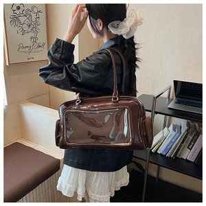 Detail view of large brown glossy PU shoulder bag with clear PVC window for daily use