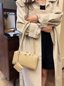 Beige rectangular shoulder bag in leather with mini pouch shown on an elegant model
