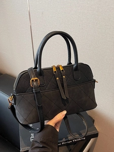 Classic black quilted shell handbag with double handles and adjustable shoulder strap