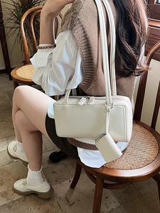 Chic beige rectangular underarm bowling bag with dual straps and mini coin purse charm