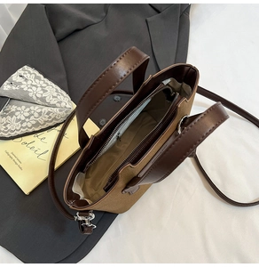 Close-up of a brown tote bag interior featuring canvas material and leather trim