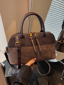 Brown quilted Boston handbag with dual top handles and adjustable shoulder strap for women
