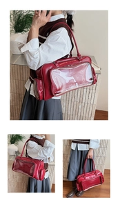 Detail of red patent leather tote bag with transparent PVC window for decorative inserts