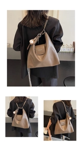 Brown oil wax leather tote backpack detail with baseball charm and magnetic flap