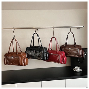 Detail view of large patent leather tote bags with clear PVC panels in four colors