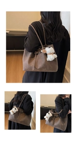 Detailed view of brown suede tote bag with slim straps and cute plush dog pendant