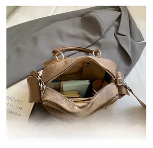 Detail view of the spacious interior of a brown vintage leather bowling bag for women