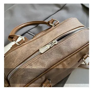 Detail of silver metal zipper and textured twill fabric on a vintage brown bowling bag
