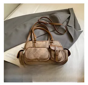 Detail of vintage brown multi-pocket tote bag with matte leather and adjustable strap