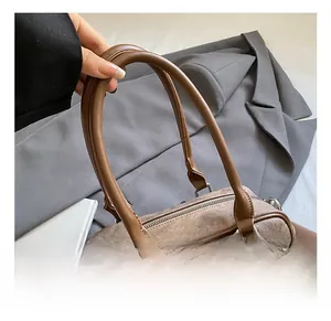 Close-up of vintage brown bowling bag with round handles and metallic D-ring hardware
