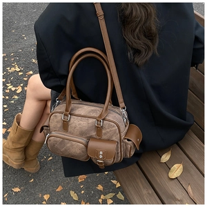 Retro multi-pocket bowling bag in dark brown patchwork shown on a park bench