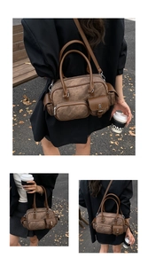 Detail of vintage brown multi-pocket bowling bag with leather trim and crossbody strap