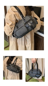 Close-up of black retro bowling bag featuring multiple utility pockets and matte leather