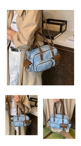 Detail of light blue bowling bag with brown leather straps and multi-pocket design