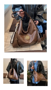 Detail of vintage brown PU leather tote bag with wooden bead charm and M logo