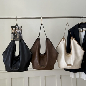 Large casual tote bags in black, brown and beige colors with minimalist logo design