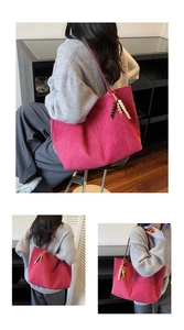 Detail view of large burgundy suede tote bag with colorful beaded charm and ample space