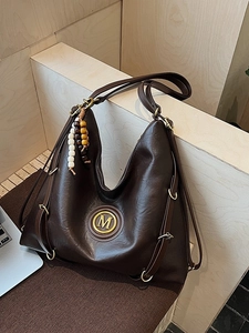 Vintage large dark brown leather hobo tote bag with gold M logo and wood bead charm