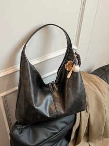 Minimalist black vintage matte leather hobo bag with baseball charm decoration on strap