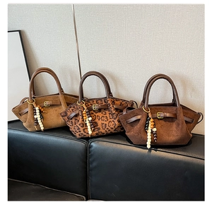 Three suede handbags in leopard print, brown and camel with ethnic beaded charms
