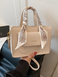 Creamy textured leather handbag for women with silk scarf handle and gold hardware detail